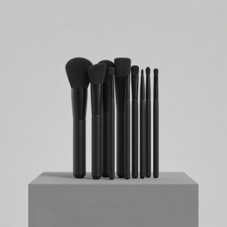 3D render of a set of black makeup brushes arranged upright on a plain stone plinth under soft light