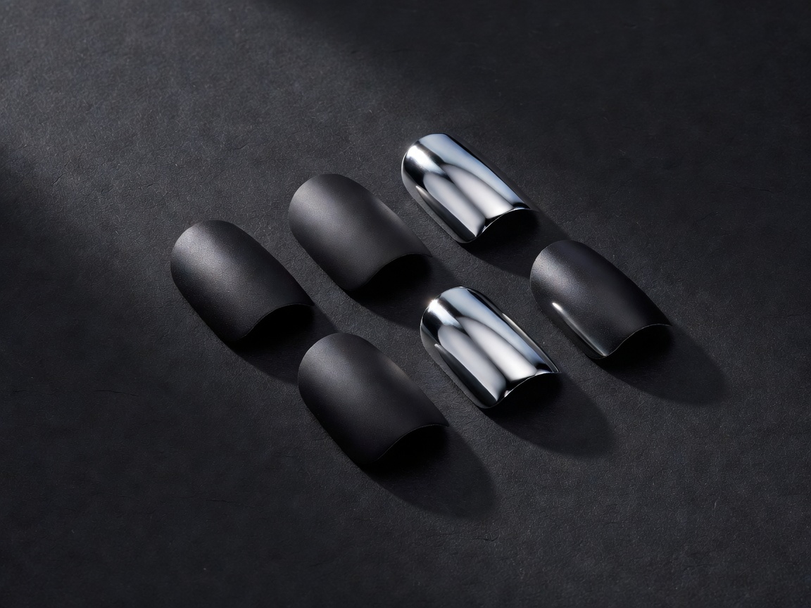 3D render of five press-on nail tips in matte black and mirror chrome arranged on a dark ground